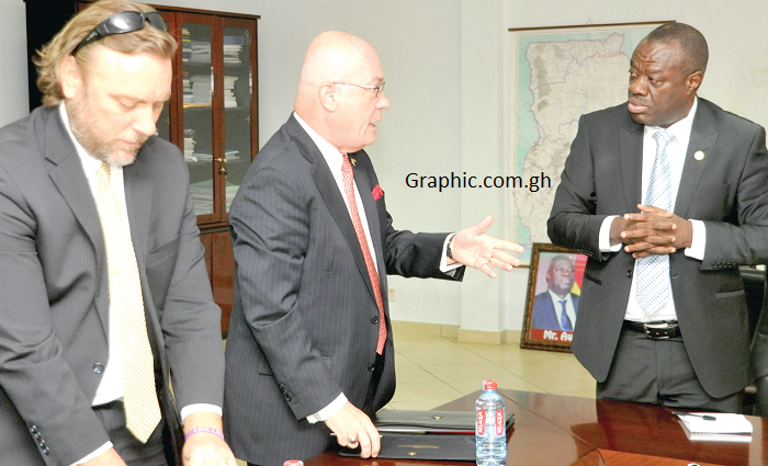  Mr Ibrahim Mohammed Awal interacting with Mr Robert Jackson. With them is Mr Kervin Sharp, the Director, Office of the US Ambassador. Picture: EBOW HANSON